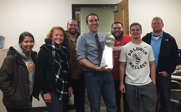 BW students honor Dr. Charles Campisi with a Lombardi Trophy.