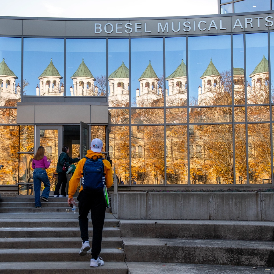 Music student on the front steps of the BW Conservatory of Performing Arts