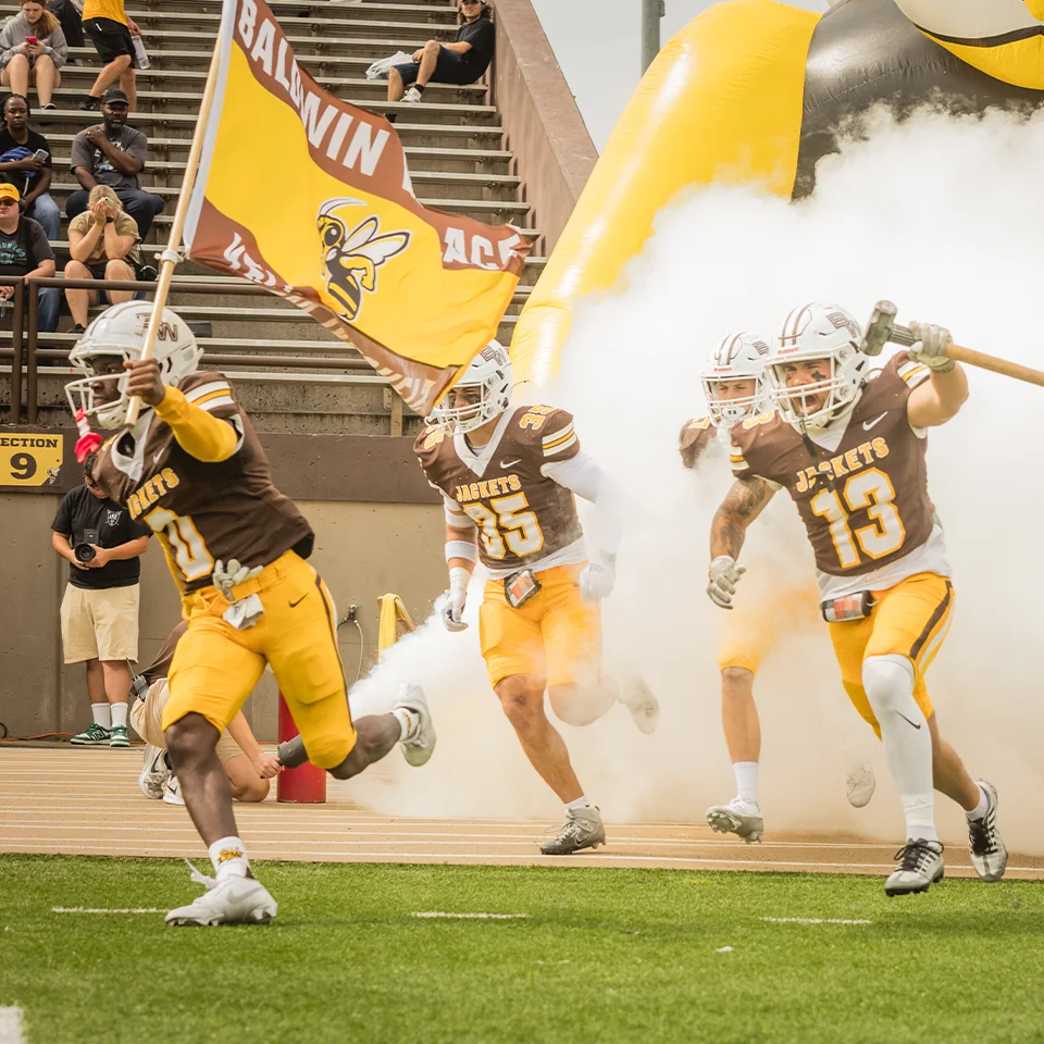 BW football players rush the field during pre-game introductions