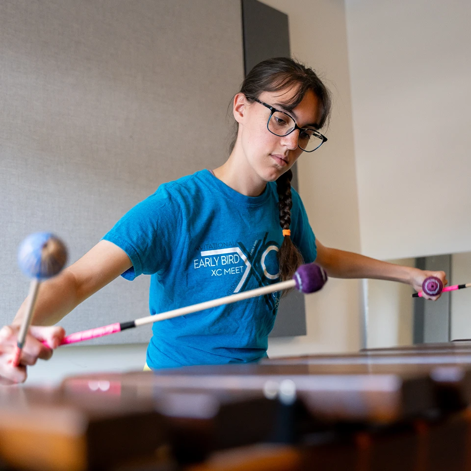 Music student practicing on a xylophone