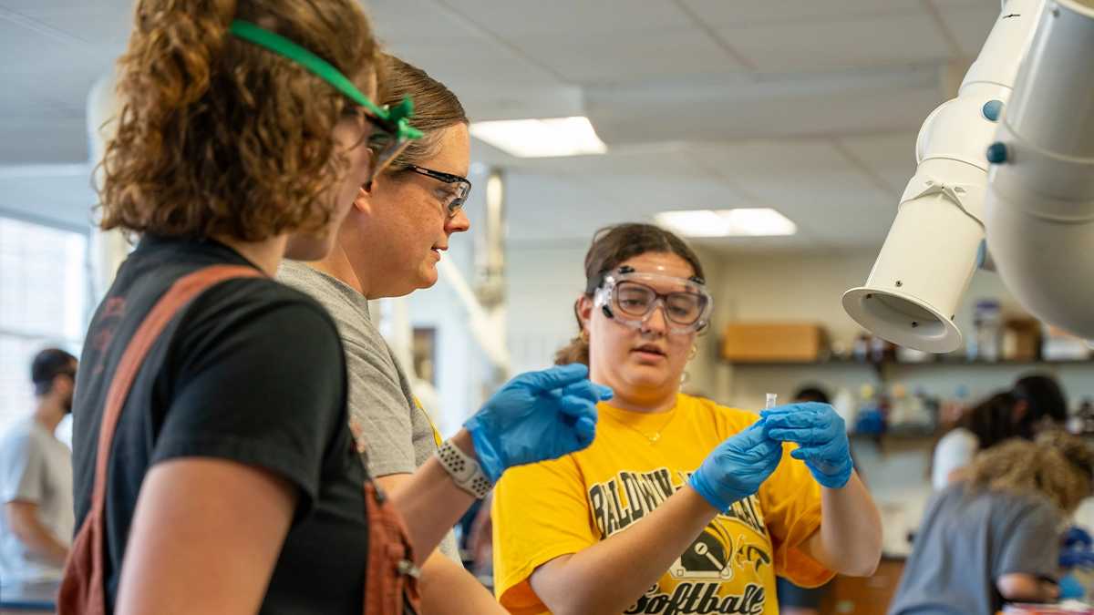 Professor and students in chemistry lab