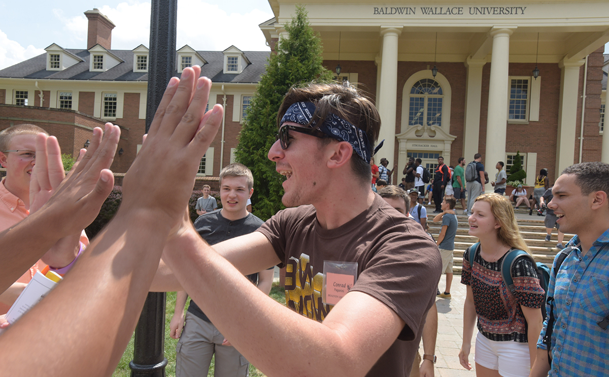 BW student orientation leader gives high fives