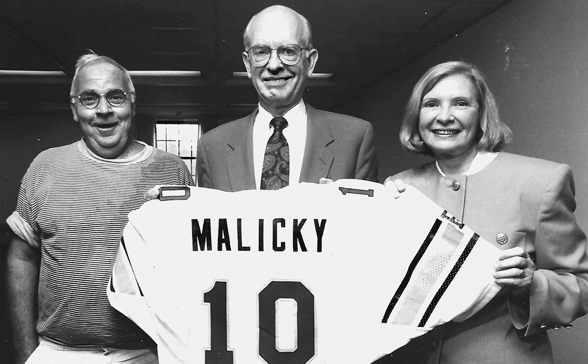 Faculty surprise President Malicky with a Yellow Jacket jersey